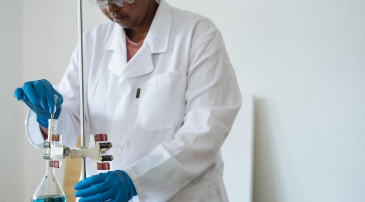 Focused African researcher conducting biochemical experiments
